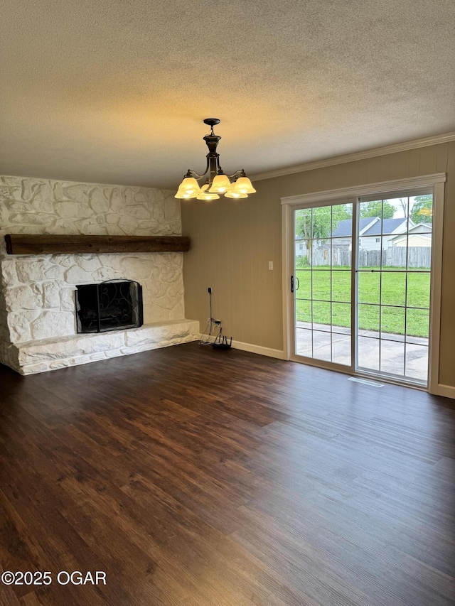 2119 S Main St, Carthage, MO 64836 - unfurnished living room with ornamental molding, wood finished floors, a chandelier, a stone fireplace, and a textured ceiling