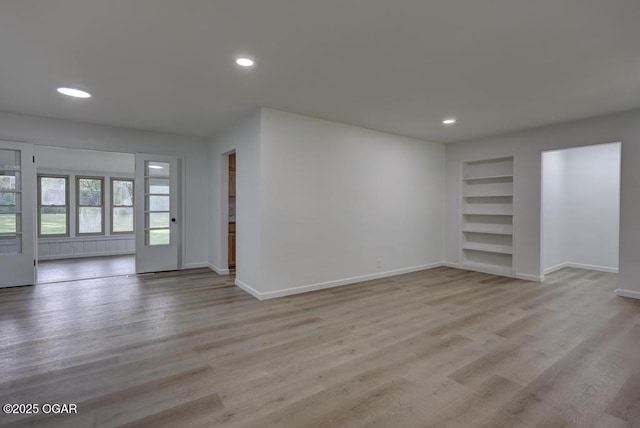 328 E 33rd St, Joplin, MO 64804 - unfurnished living room with built in features, baseboards, light wood-style flooring, and recessed lighting