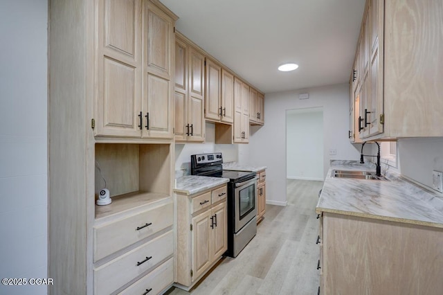 328 E 33rd St, Joplin, MO 64804 - kitchen with stainless steel range with electric stovetop, a sink, light brown cabinetry, and baseboards