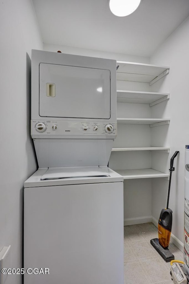 328 E 33rd St, Joplin, MO 64804 - laundry area with stacked washing machine and dryer and baseboards
