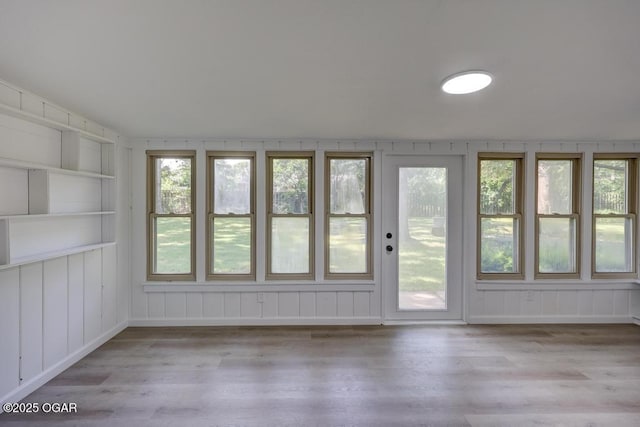 328 E 33rd St, Joplin, MO 64804 - unfurnished sunroom with wood finished floors and a decorative wall