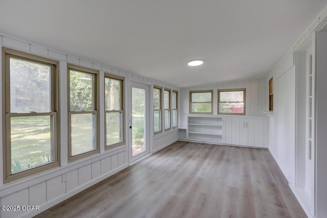 328 E 33rd St, Joplin, MO 64804 - unfurnished sunroom with wood finished floors and healthy amount of natural light