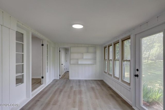 328 E 33rd St, Joplin, MO 64804 - unfurnished sunroom featuring wood finished floors and baseboards