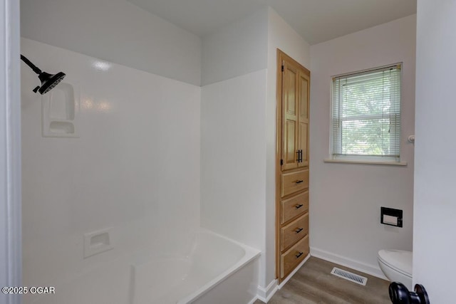 328 E 33rd St, Joplin, MO 64804 - full bathroom with a bath, toilet, wood finished floors, baseboards, and a shower