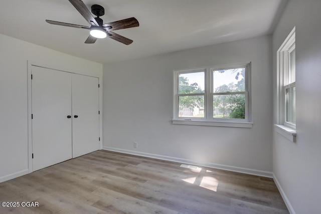 328 E 33rd St, Joplin, MO 64804 - unfurnished bedroom featuring wood finished floors, baseboards, a ceiling fan, and a closet