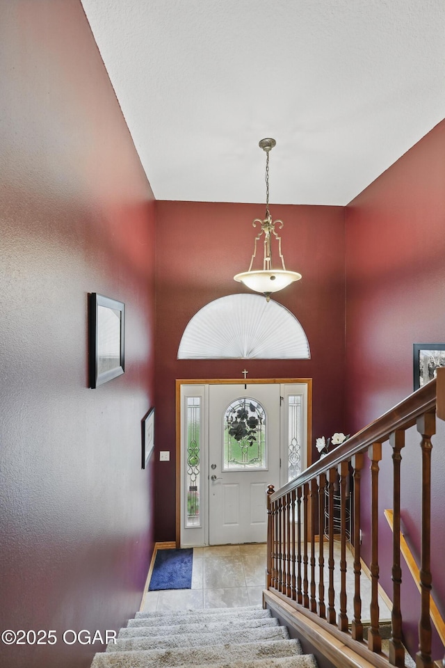 702 Copper Oaks Dr, Carl Junction, MO 64834 - foyer entrance with stairs, baseboards, tile patterned flooring, and a towering ceiling