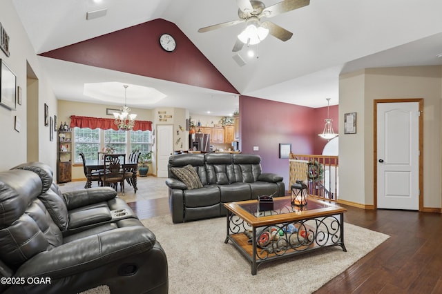 702 Copper Oaks Dr, Carl Junction, MO 64834 - living room featuring a chandelier, a ceiling fan, wood finished floors, and high vaulted ceiling