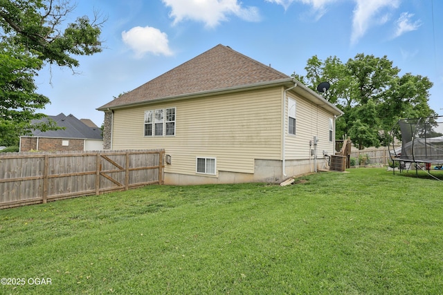 702 Copper Oaks Dr, Carl Junction, MO 64834 - back of house with a trampoline and central AC unit