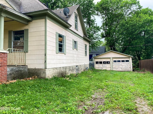 402 N Connor Ave, Joplin, MO 64801 - view of property exterior featuring roof with shingles, a detached garage, and an outbuilding