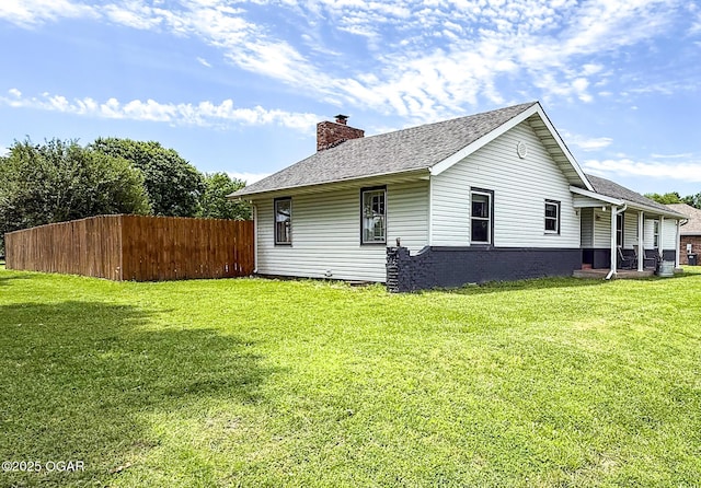 706 E Centennial E, Centennial, Pittsburg, KS 66762 - view of property exterior with a chimney and a shingled roof
