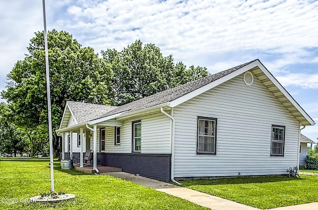 706 E Centennial E, Centennial, Pittsburg, KS 66762 - view of property exterior with a porch, a yard, and a shingled roof