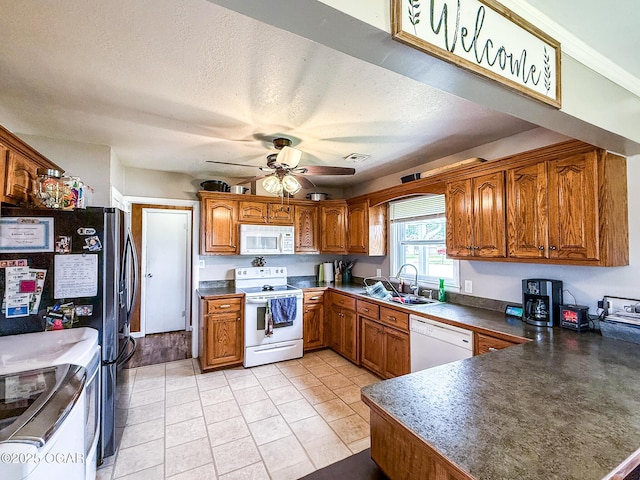706 E Centennial E, Centennial, Pittsburg, KS 66762 - kitchen with white appliances, brown cabinets, a sink, a peninsula, and ceiling fan