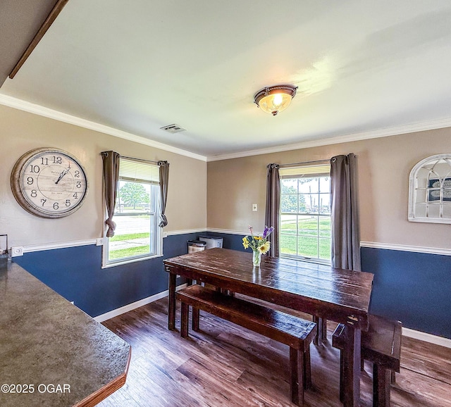 706 E Centennial E, Centennial, Pittsburg, KS 66762 - dining space featuring plenty of natural light, wood finished floors, crown molding, and baseboards