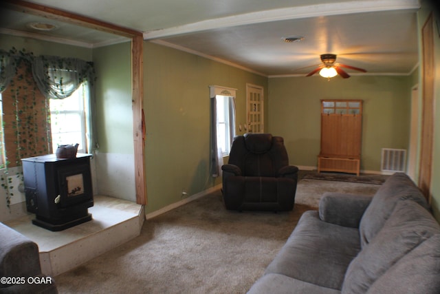 423 Mower St, Duenweg, MO 64841 - carpeted living room featuring a wood stove, a ceiling fan, crown molding, and baseboards