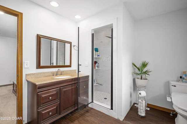 3431 Hawthorn Dr, Joplin, MO 64804 - bathroom featuring toilet, a marble finish shower, vanity, wood finished floors, and baseboards