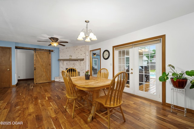 3431 Hawthorn Dr, Joplin, MO 64804 - dining room with a chandelier, dark wood-style flooring, a barn door, french doors, and baseboards