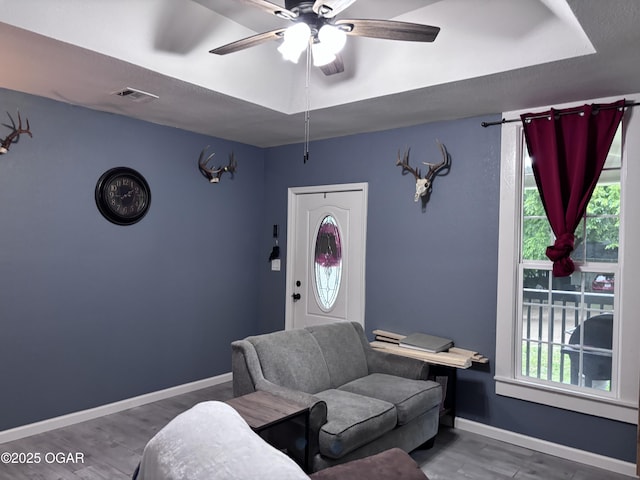 324 W Hill St, Neosho, MO 64850 - living area featuring ceiling fan, wood finished floors, and baseboards