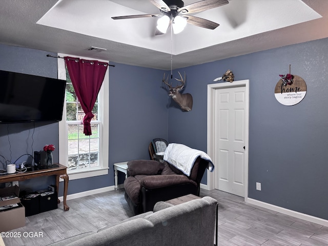 324 W Hill St, Neosho, MO 64850 - sitting room with ceiling fan, wood finished floors, and baseboards