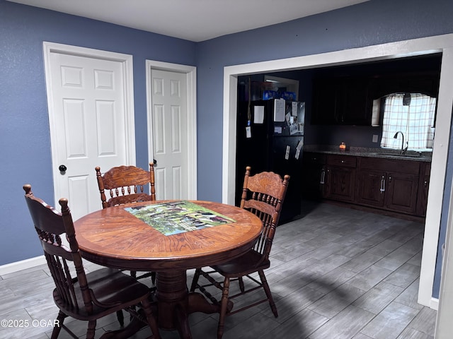 324 W Hill St, Neosho, MO 64850 - dining room featuring light wood-type flooring and baseboards