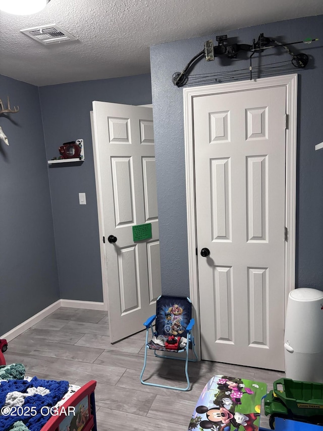 324 W Hill St, Neosho, MO 64850 - interior space with a textured ceiling and light wood-type flooring
