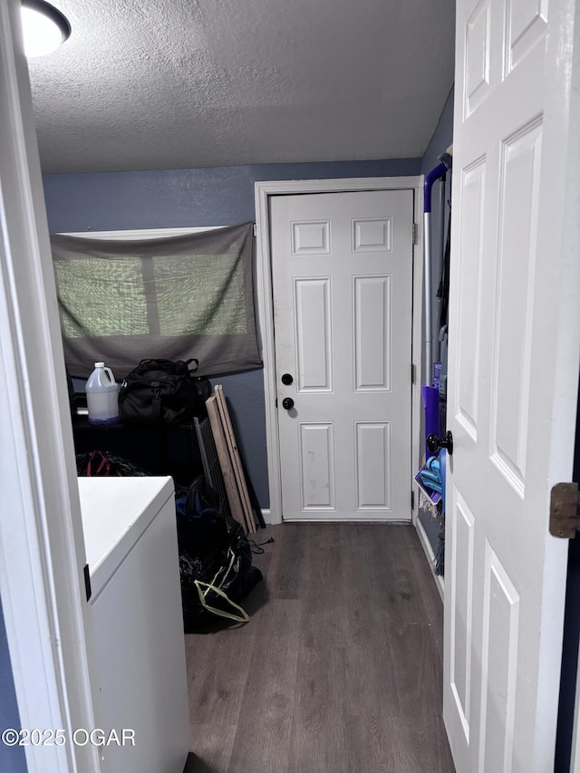 324 W Hill St, Neosho, MO 64850 - washroom with dark wood-type flooring, a textured ceiling, and washer / dryer