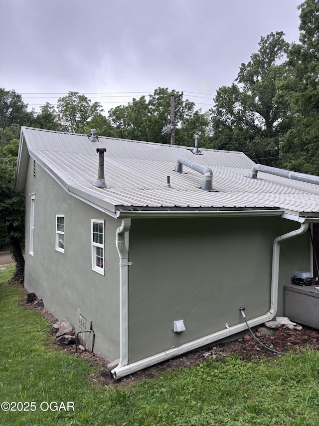 324 W Hill St, Neosho, MO 64850 - back of house with stucco siding and metal roof