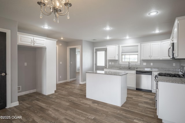 1704 Texas Ave, Joplin, MO 64804 - kitchen featuring stainless steel appliances, a sink, white cabinetry, recessed lighting, and a kitchen island