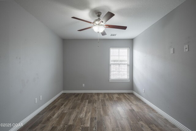 1704 Texas Ave, Joplin, MO 64804 - empty room featuring a ceiling fan, dark wood finished floors, baseboards, and a textured ceiling