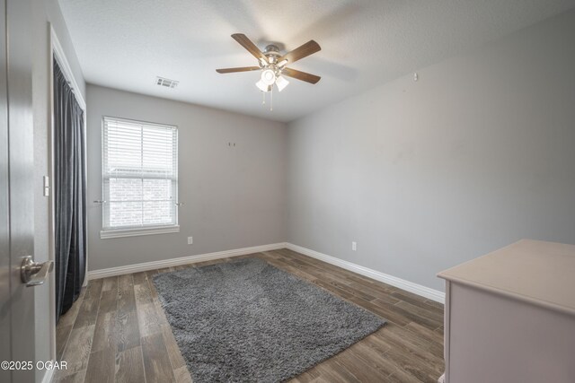 1704 Texas Ave, Joplin, MO 64804 - spare room featuring baseboards, wood finished floors, and a ceiling fan