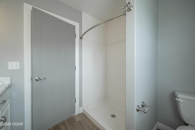 1704 Texas Ave, Joplin, MO 64804 - full bath featuring toilet, vanity, a tile shower, and wood finished floors