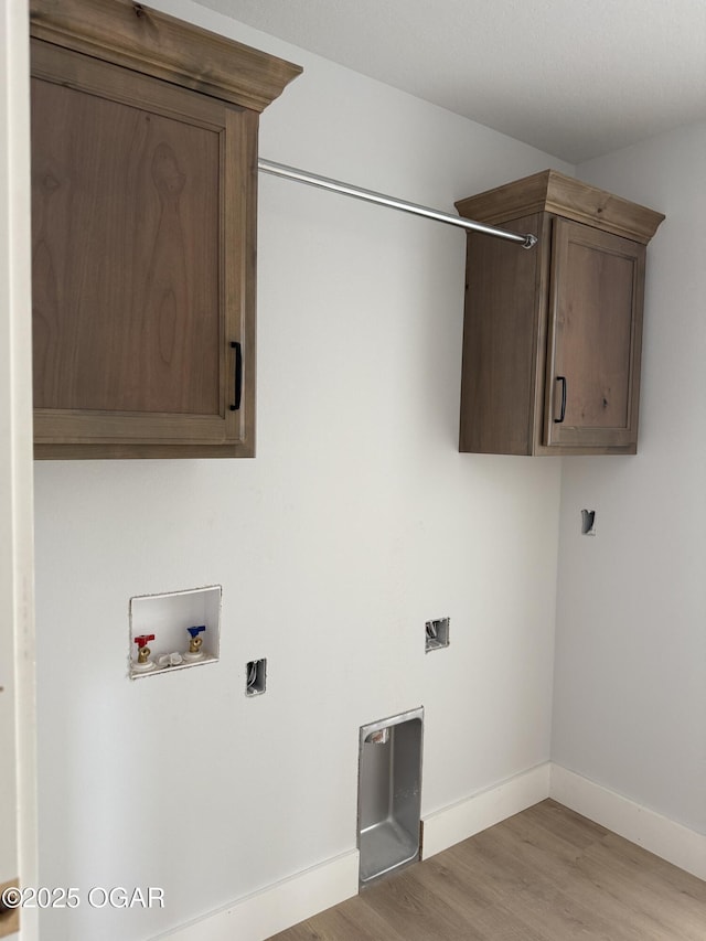 2006 E Quincy St, Joplin, MO 64801 - washroom with washer hookup, cabinet space, light wood-style flooring, and baseboards
