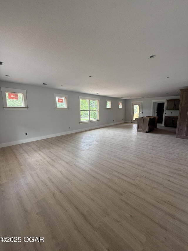 2006 E Quincy St, Joplin, MO 64801 - unfurnished living room featuring light wood-type flooring and baseboards