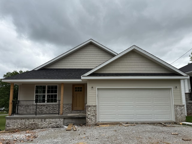 2006 E Quincy St, Joplin, MO 64801 - view of front of property featuring covered porch, driveway, an attached garage, and brick siding