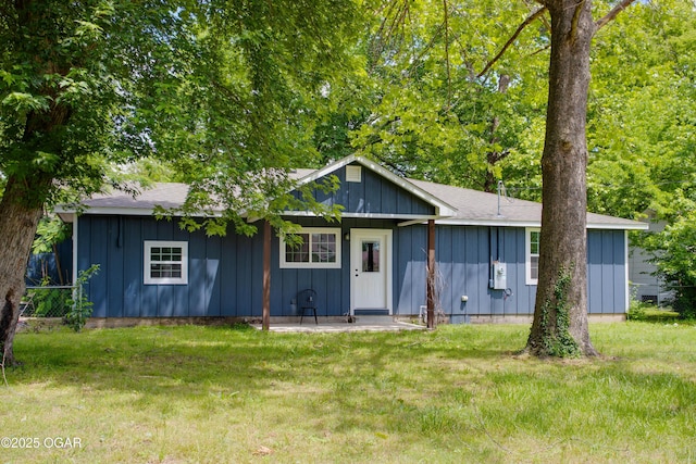1002 S Mill St, Grove, OK 74344 - ranch-style house featuring board and batten siding, a front lawn, and a shingled roof