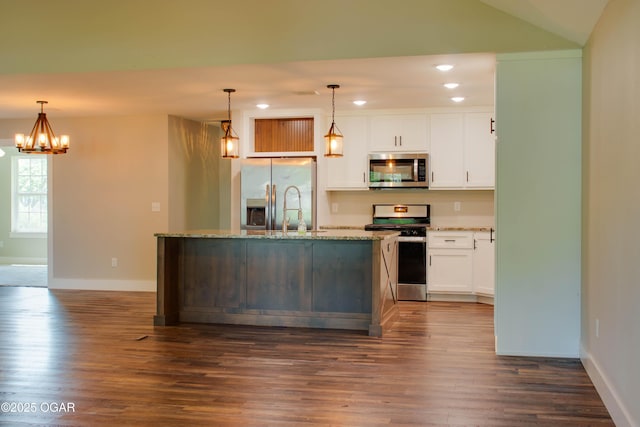 1002 S Mill St, Grove, OK 74344 - kitchen featuring appliances with stainless steel finishes, recessed lighting, dark wood-style flooring, an island with sink, and white cabinetry