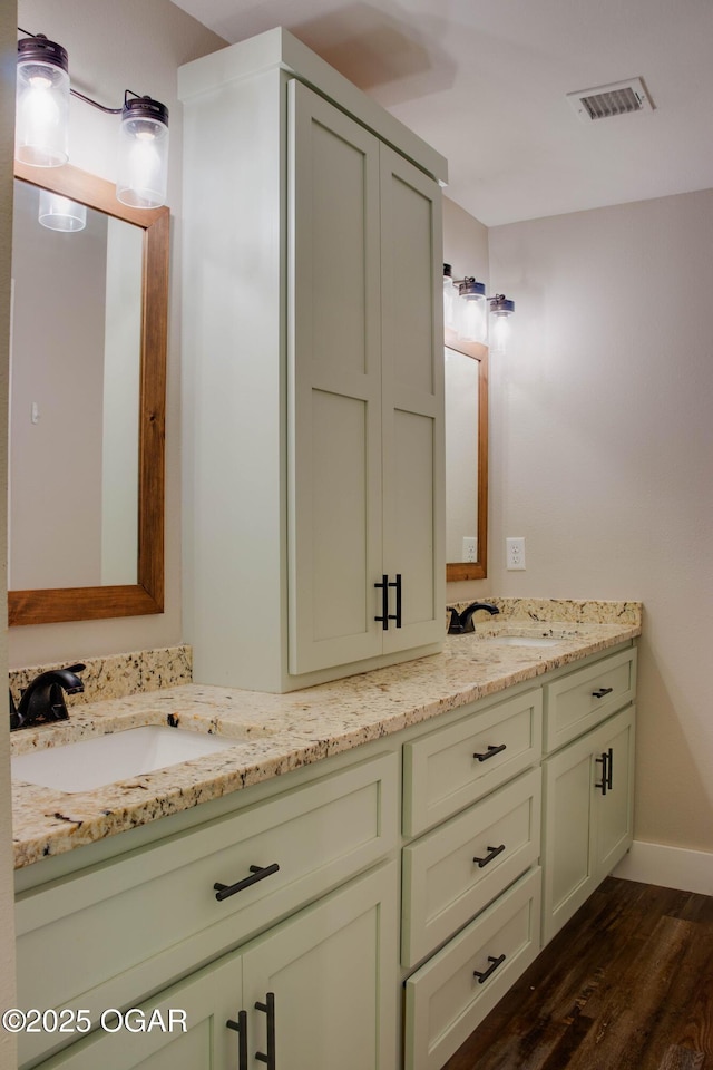 1002 S Mill St, Grove, OK 74344 - full bath featuring double vanity, wood finished floors, and baseboards