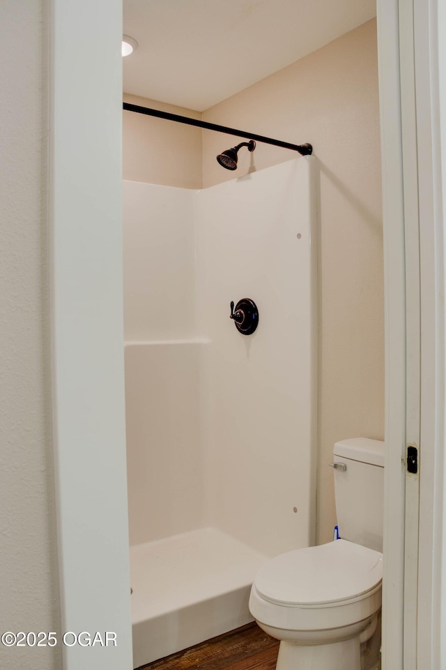1002 S Mill St, Grove, OK 74344 - bathroom with a shower, toilet, and wood finished floors