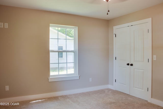 1002 S Mill St, Grove, OK 74344 - unfurnished bedroom featuring carpet flooring, a closet, and baseboards