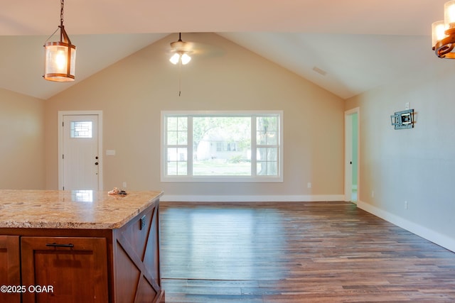 1002 S Mill St, Grove, OK 74344 - kitchen with wood finished floors, ceiling fan, baseboards, vaulted ceiling, and brown cabinets