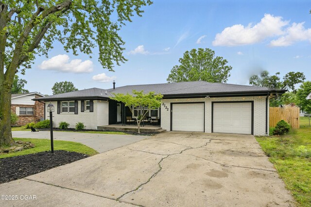 2722 Wisconsin Ave, Joplin, MO 64804 - ranch-style house with brick siding, driveway, and an attached garage