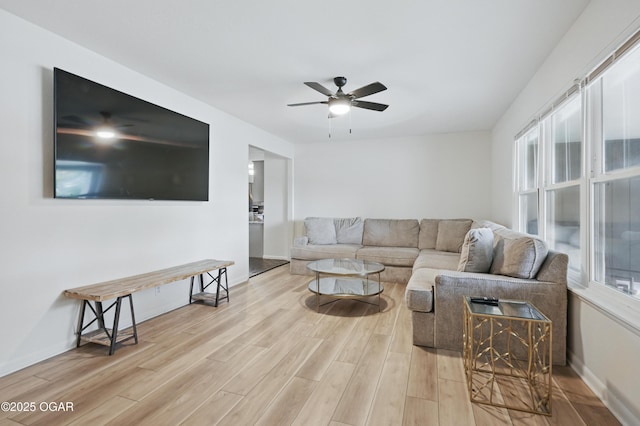 2722 Wisconsin Ave, Joplin, MO 64804 - living area with light wood-style floors, healthy amount of natural light, ceiling fan, and baseboards