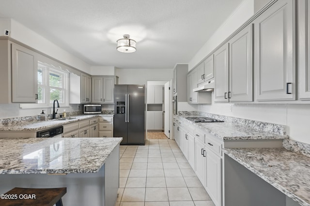 2722 Wisconsin Ave, Joplin, MO 64804 - kitchen with appliances with stainless steel finishes, a sink, light stone counters, and light tile patterned floors