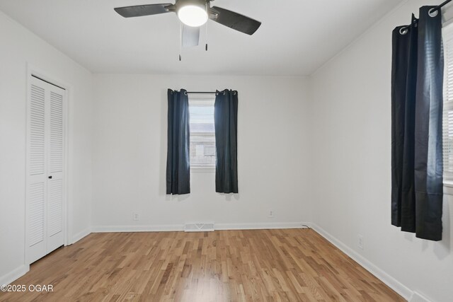 2722 Wisconsin Ave, Joplin, MO 64804 - unfurnished bedroom featuring light wood-style flooring, baseboards, a closet, and ceiling fan