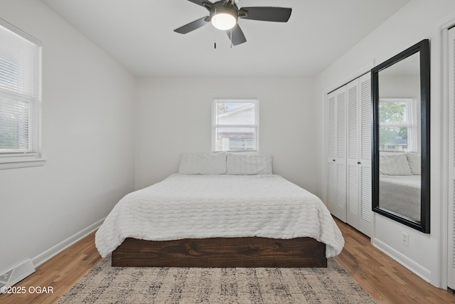 2722 Wisconsin Ave, Joplin, MO 64804 - bedroom with multiple windows, wood finished floors, and a closet