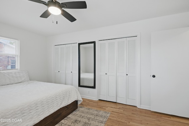2722 Wisconsin Ave, Joplin, MO 64804 - bedroom featuring multiple closets, light wood-type flooring, baseboards, and ceiling fan