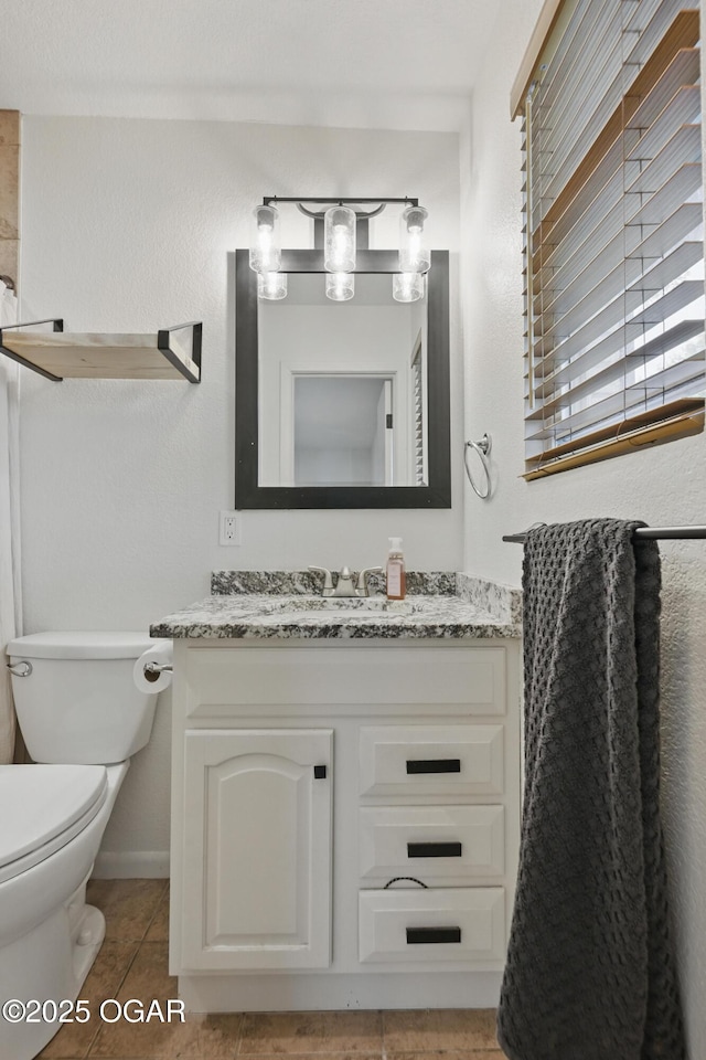 2722 Wisconsin Ave, Joplin, MO 64804 - bathroom with vanity, toilet, tile patterned floors, and baseboards