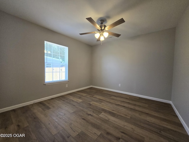 504 S Mckinley Ave, Joplin, MO 64801 - spare room featuring dark wood finished floors, a ceiling fan, and baseboards