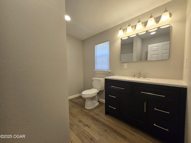 504 S Mckinley Ave, Joplin, MO 64801 - bathroom featuring wood finished floors, vanity, toilet, and baseboards