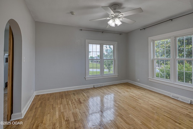 2502 S Tyler Ave, Joplin, MO 64804 - spare room featuring arched walkways, plenty of natural light, and light wood-style flooring