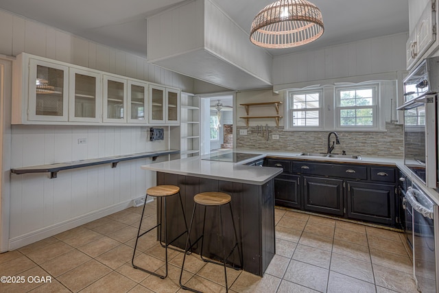 2502 S Tyler Ave, Joplin, MO 64804 - kitchen featuring a sink, light tile patterned flooring, a kitchen bar, open shelves, and white cabinets